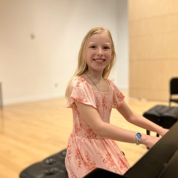 Catherine Dickinson sitting at a piano